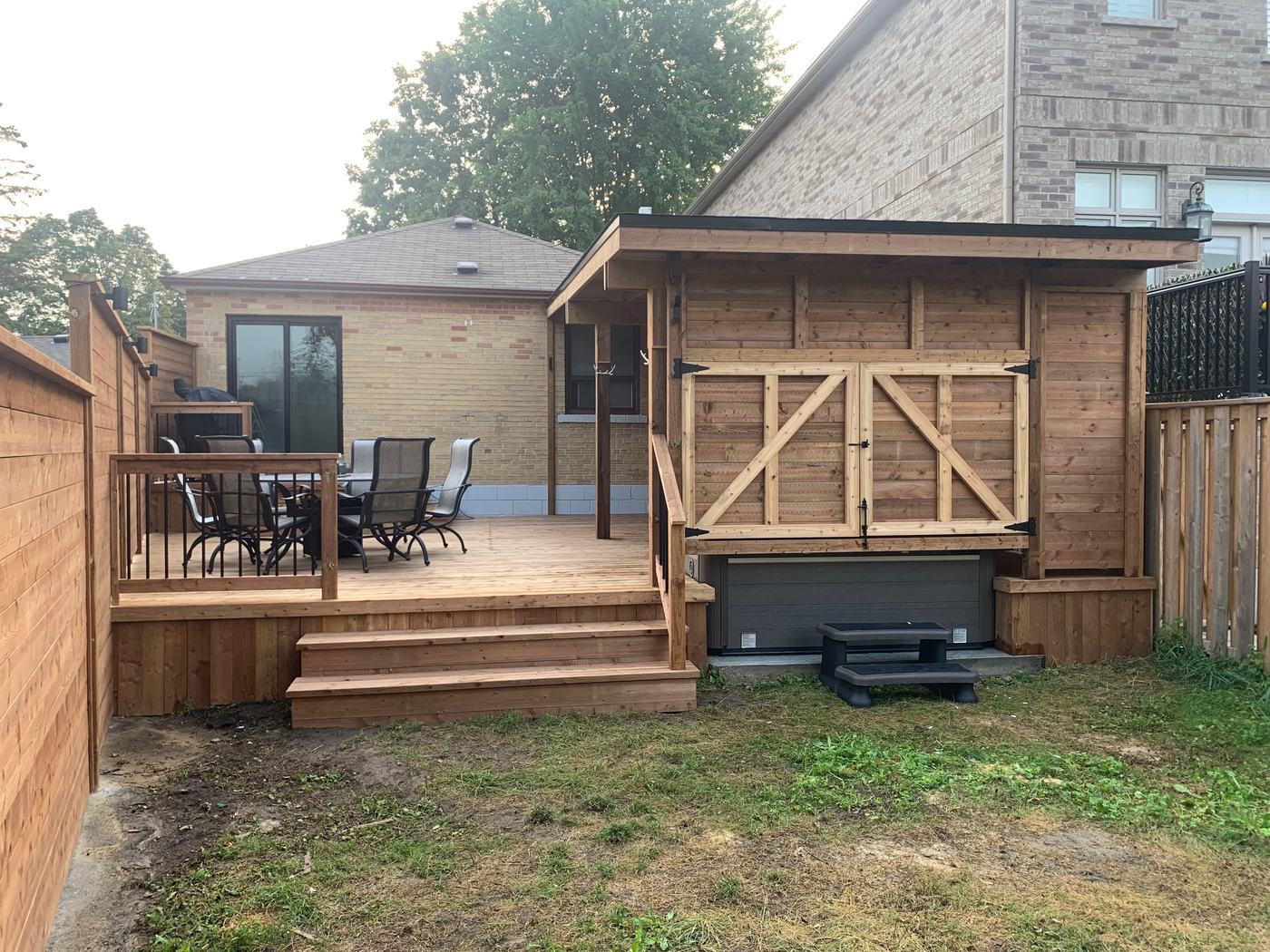Cedar deck with built-in hot tub cabana and seating area