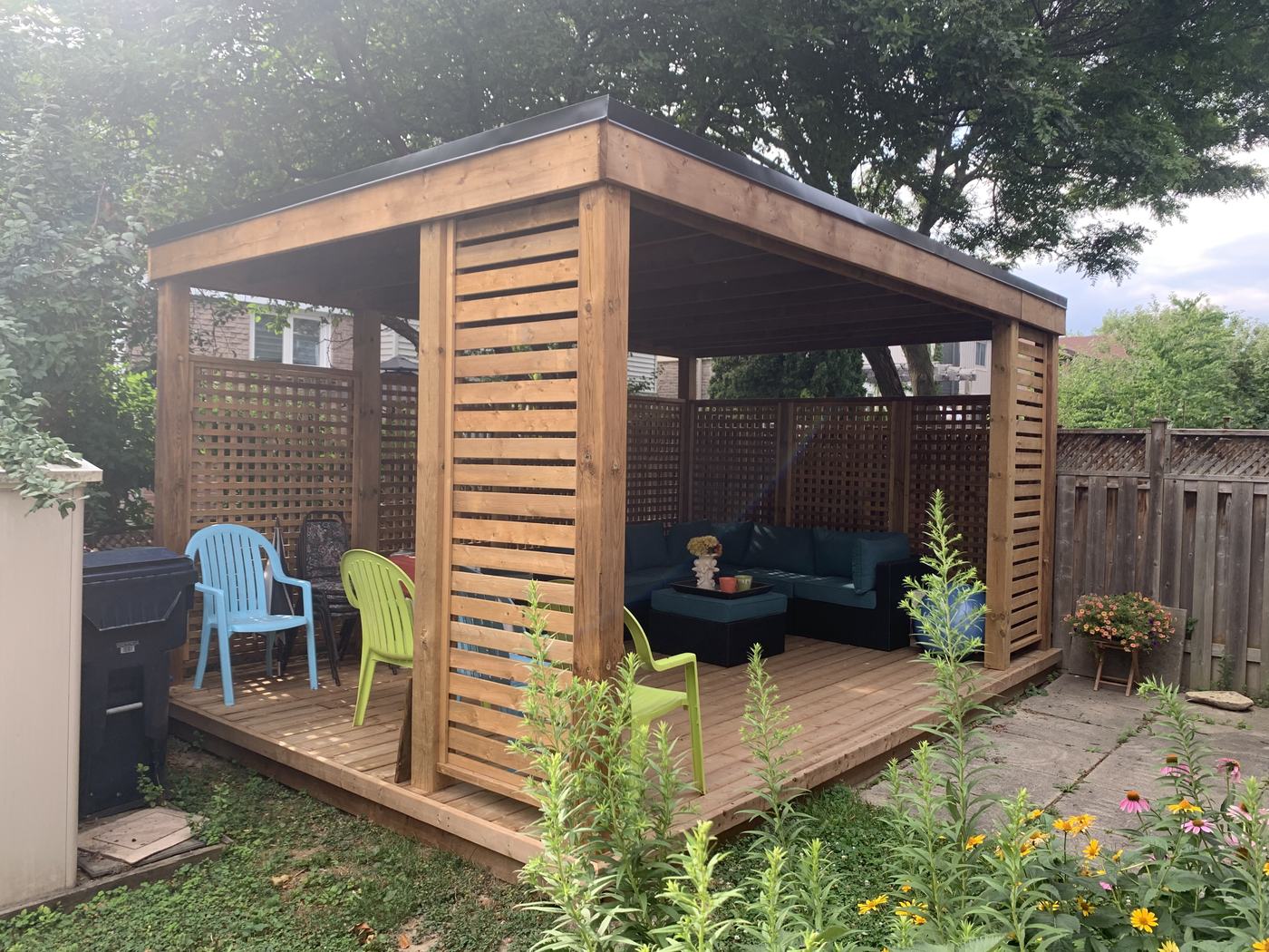 Cedar gazebo with lattice privacy walls and lounge seating