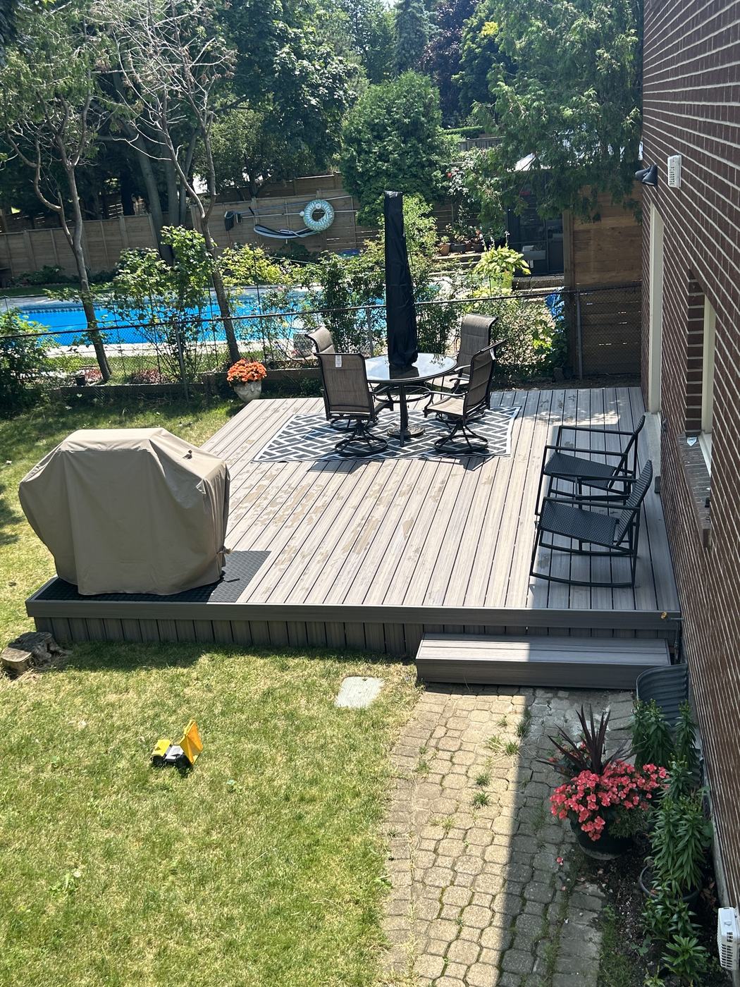 Composite deck with dining set overlooking the pool