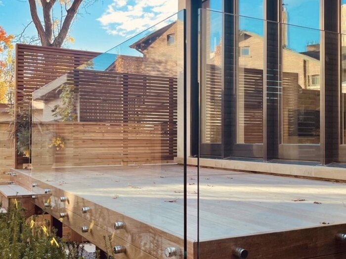 Frameless glass panel railing on an elevated composite deck