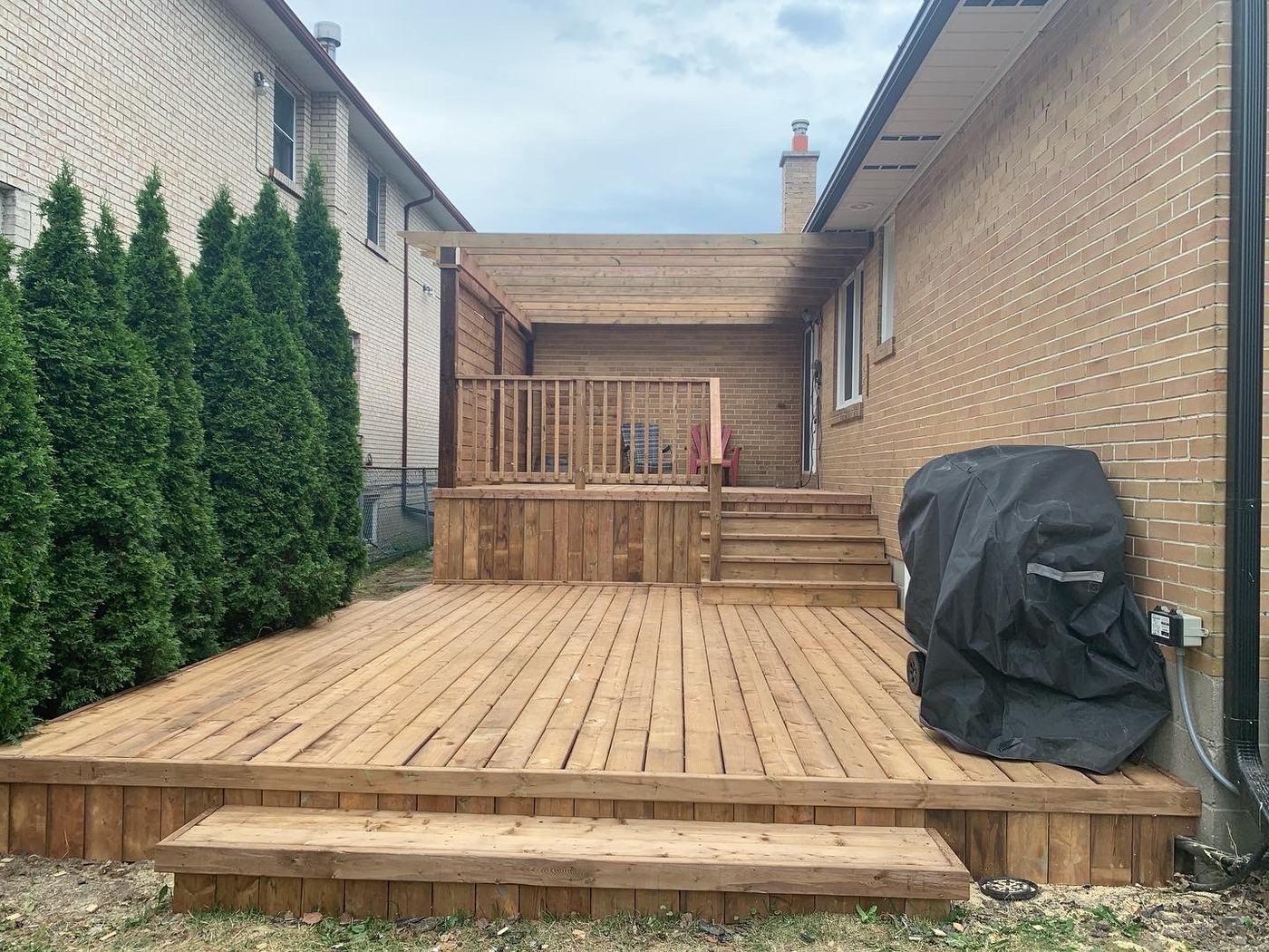 Pressure-treated wood deck with covered grill area