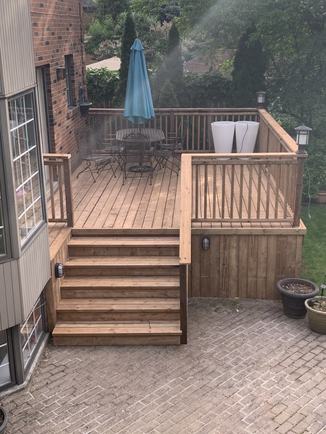 Pressure-treated deck with dining set and umbrella