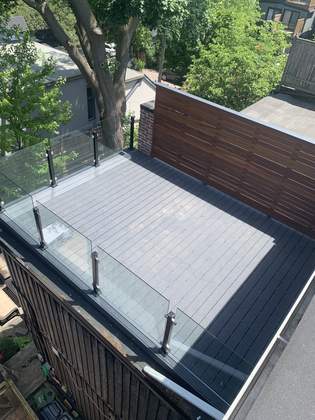 Rooftop composite deck with glass railing and cedar privacy wall